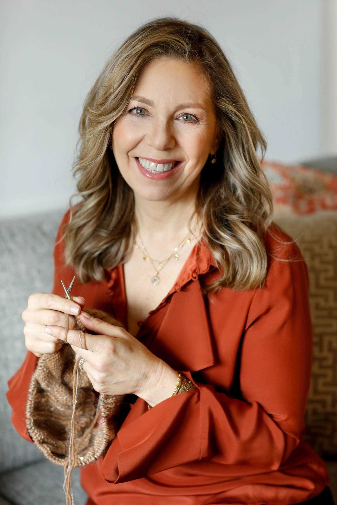 Lisa Hoffman, knitwear designer, holding knitting needles